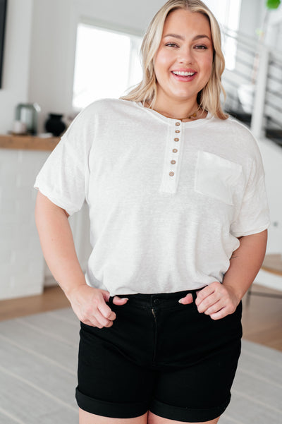Be effortlessly cool with our Hipster Henley Top! Made with a woven fabric, it features a round neckline and functional front button closure. The drop shoulder and exposed seam patch pocket add a touch of personality, while the scooped high low hem adds a unique twist