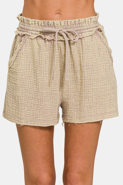 The frayed hem adds a touch of edgy detail to the design. The drawstring waist allows for a comfortable and adjustable fit. Pair these shorts with a tank top and sneakers for a laid-back and effortless look. Whether you're running errands or heading to the beach, these shorts are a chic and practical choice for any summer outing.