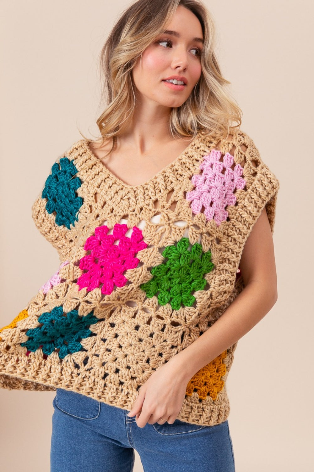 The Granny Square Openwork Sweater Vest is a stylish and versatile addition to any wardrobe