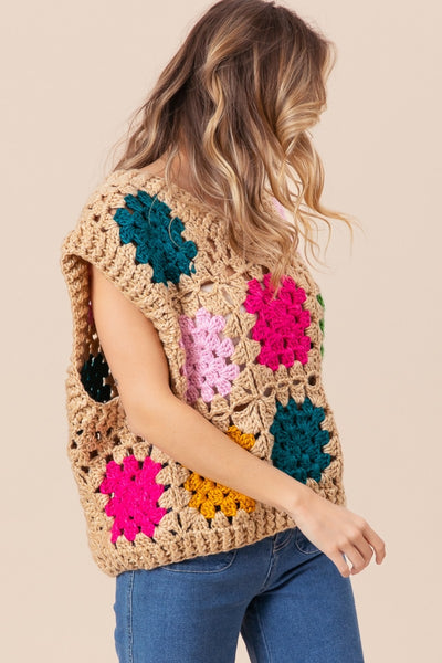 The Granny Square Openwork Sweater Vest is a stylish and versatile addition to any wardrobe