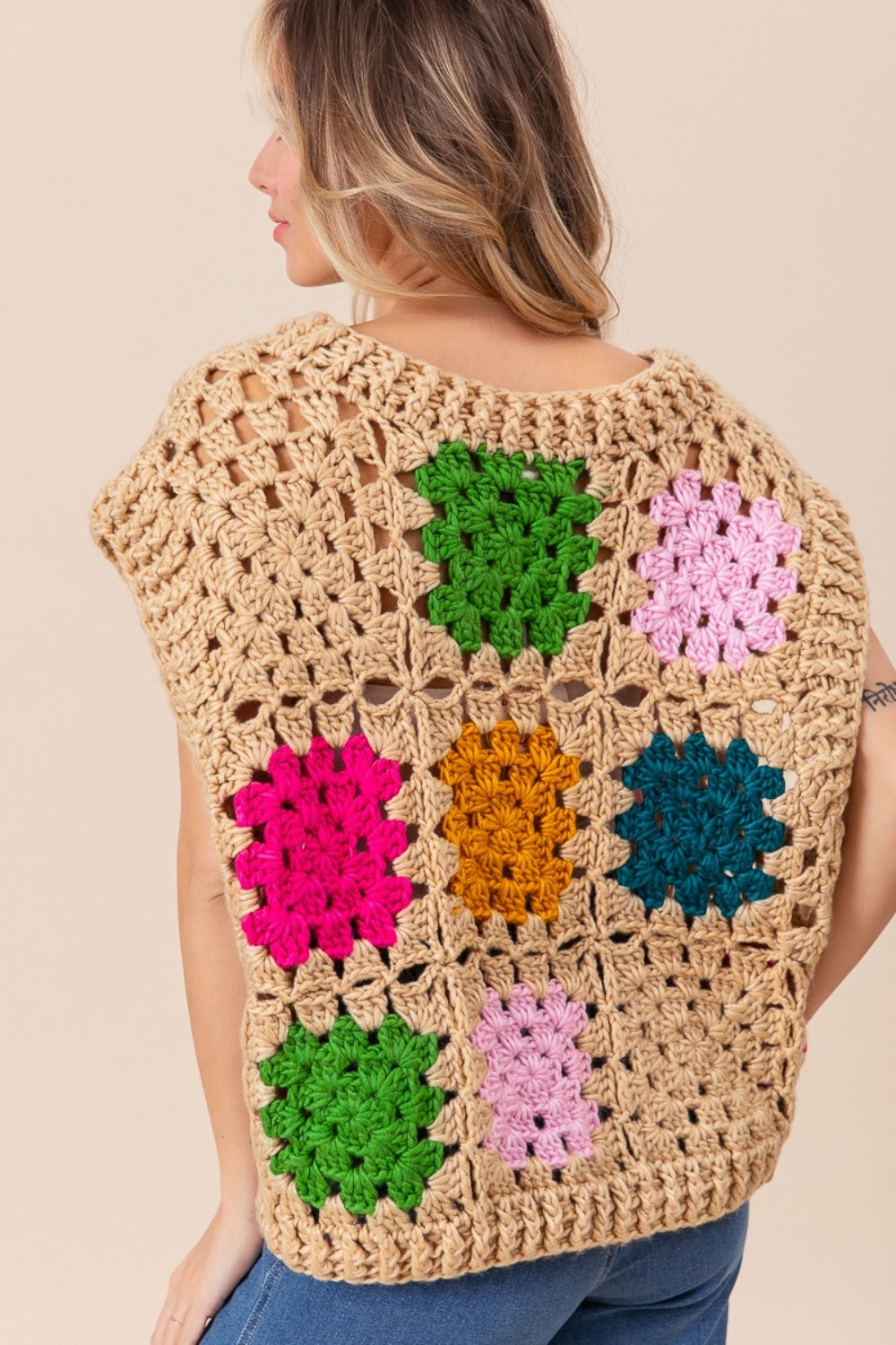 The Granny Square Openwork Sweater Vest is a stylish and versatile addition to any wardrobe