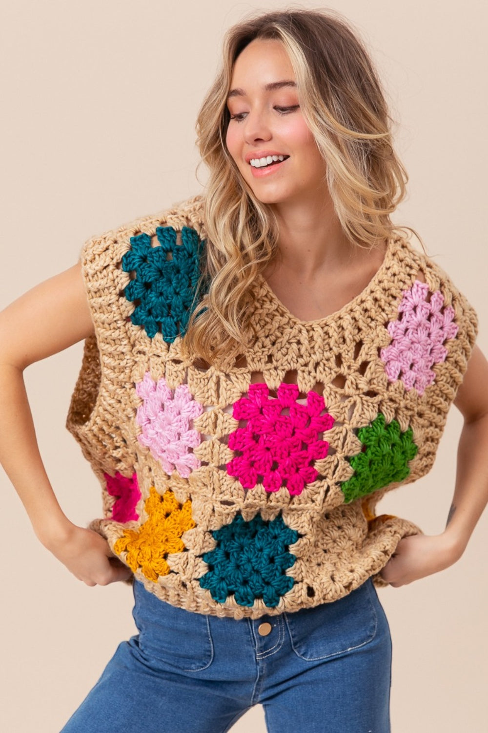 The Granny Square Openwork Sweater Vest is a stylish and versatile addition to any wardrobe