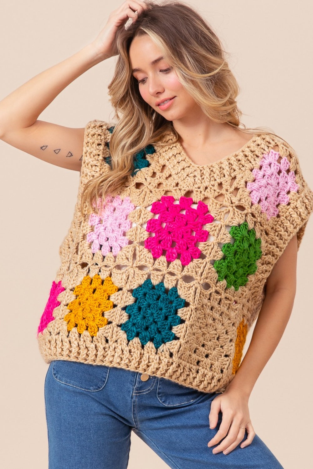 The Granny Square Openwork Sweater Vest is a stylish and versatile addition to any wardrobe