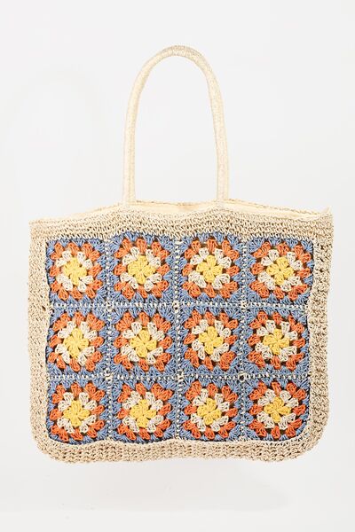 The Flower Braided Tote Bag is a charming and stylish accessory perfect for adding a touch of bohemian flair to your outfit