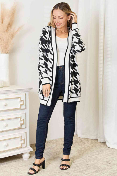 Crafted in a classic houndstooth pattern, this open-front longline cardigan exudes elegance and versatility