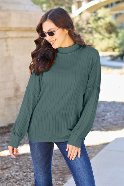 Our Ribbed Exposed Seam Mock Neck Knit Top is made from a lightweight and breathable material, giving you all-day comfort and style