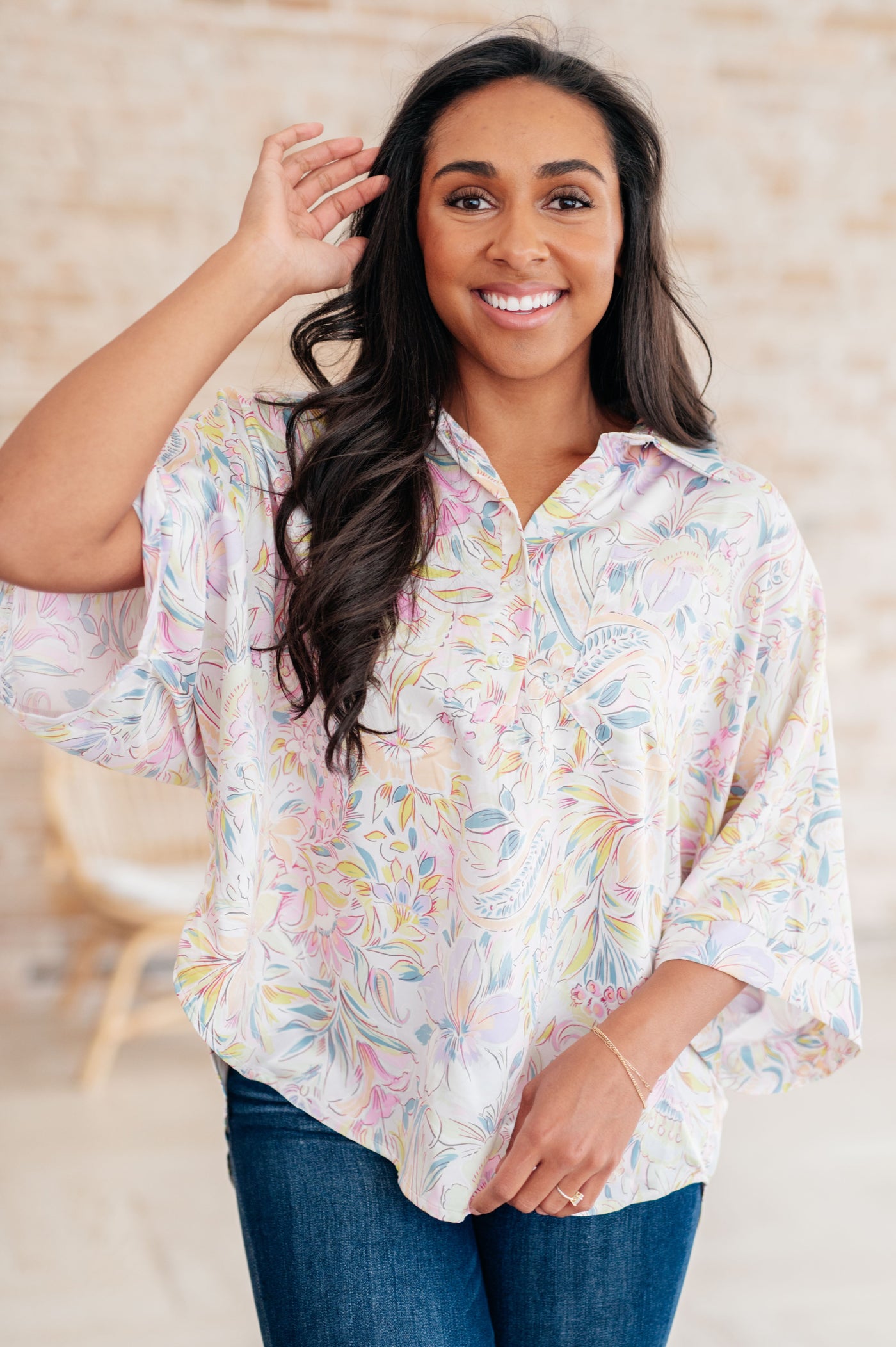 Made with lush Poly Satin, this blouse features a collared neckline, half front button closures, and a playful bat wing design. Complete with a patch pocket, banded sleeve cuffs, and a high-low scooped hem.