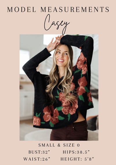 Made with soft and lightweight waffle knit, this hoodie features playful floral accents, a cozy hood, and a unique scooped hem