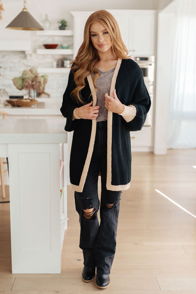 Featuring an open front, balloon sleeves, and contrast trim, this soft sweater knit cardigan will have you looking stylish and feeling comfy.