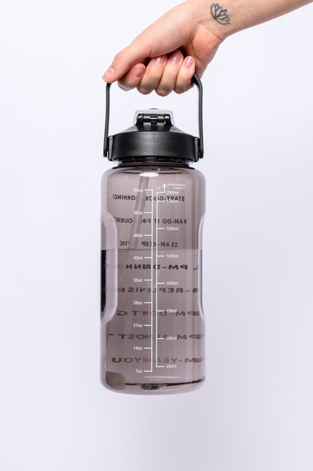 Quench your thirst with the Elevated Water Tracking Bottle in Black! This enchanting 64-ounce bottle is adorned with adorable inspirational sayings, urging you to sip your way to hydration bliss