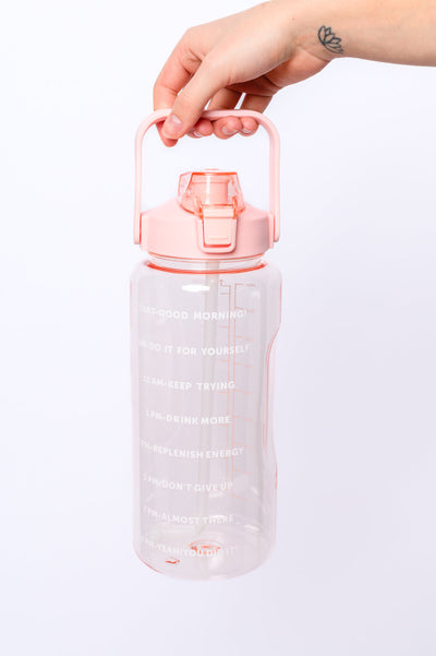 Quench your thirst with the Elevated Water Tracking Bottle in Pink! This enchanting 64-ounce bottle is adorned with adorable inspirational sayings, urging you to sip your way to hydration bliss