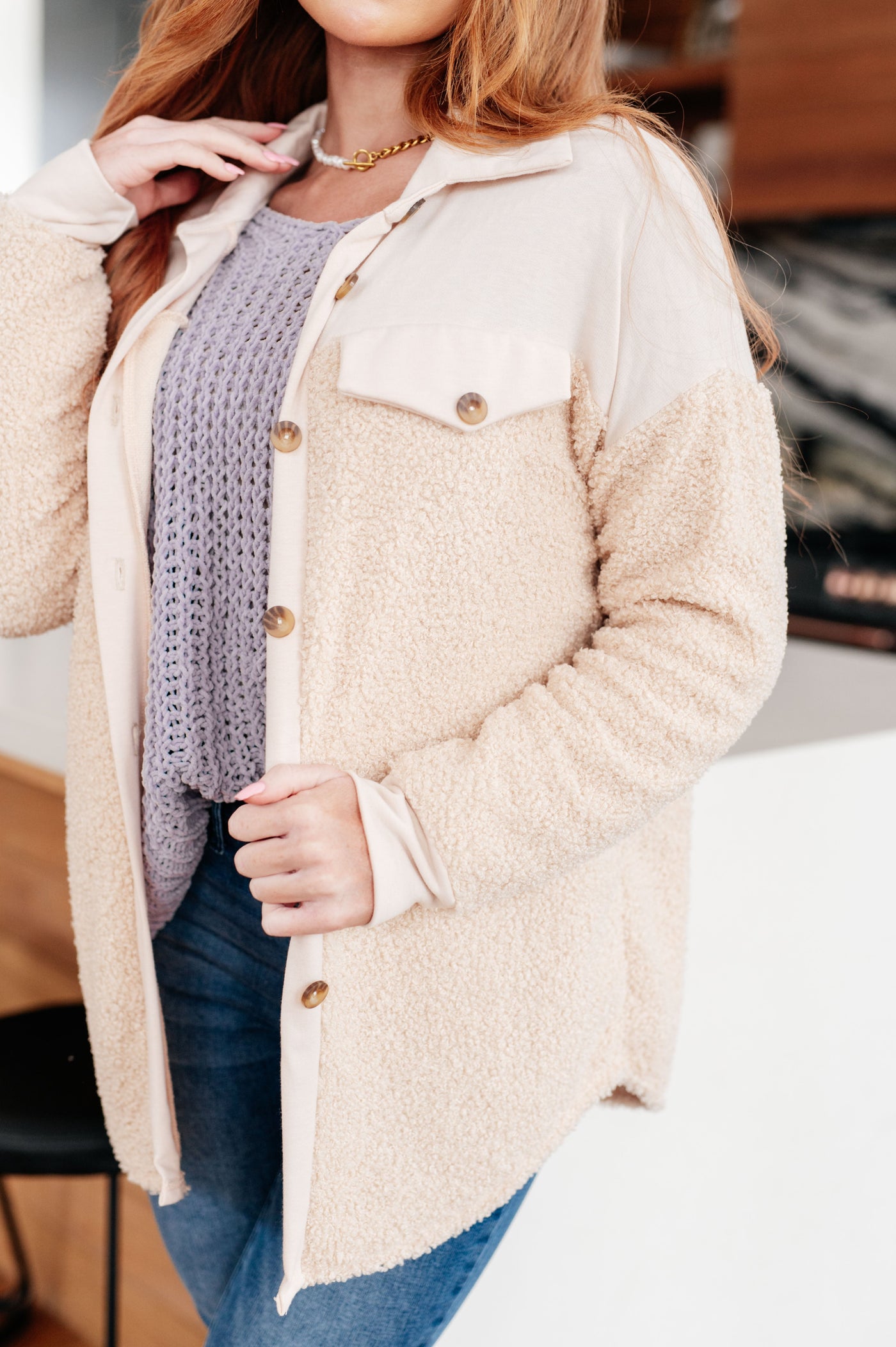Made from cozy sherpa fleece and jersey knit, this shacket features a collared neckline and adorable faux pockets