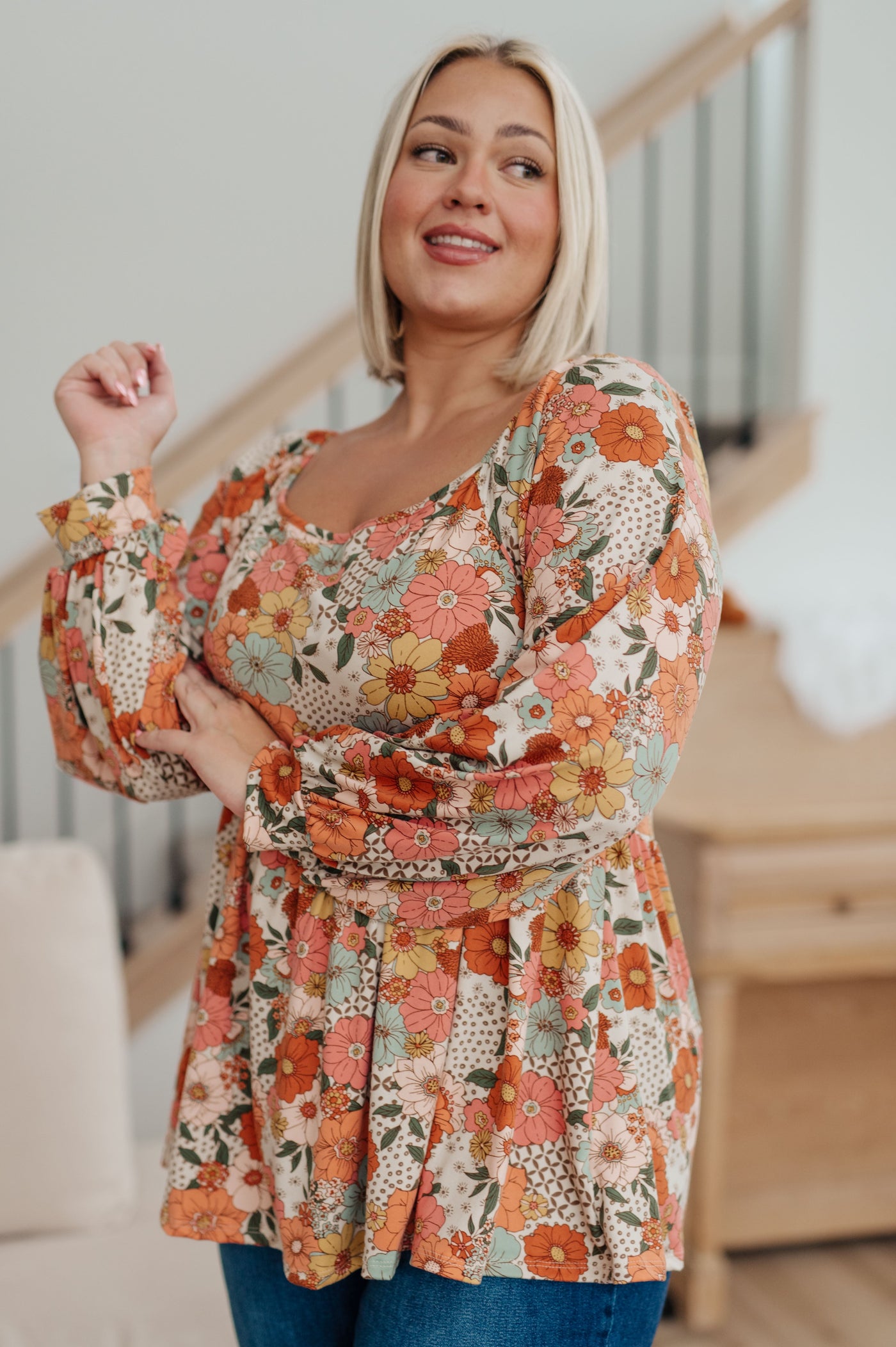 Look effortlessly stylish in our Fall For Florals Babydoll Top. This sweet, feminine style features a mixed-print floral pattern, buttery-soft fabric and balloon sleeves for a comfortable and flattering look