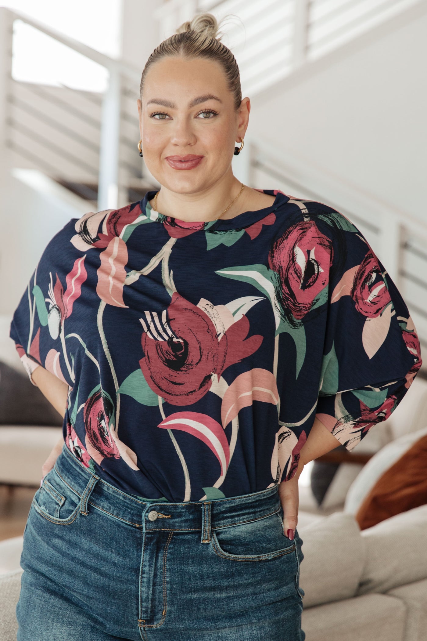 The Float On Floral Top is the perfect addition to your wardrobe. The boxy fit and cuffed dolman sleeves make it both comfortable and flattering, and the statement large scale floral print adds a touch of personality.