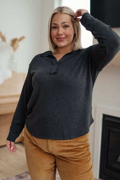 Made from a soft jersey knit, this top features exposed seams and a v-neckline that will flatter any figure. The thumb holes in the sleeve cuffs add an extra layer of warmth and style.