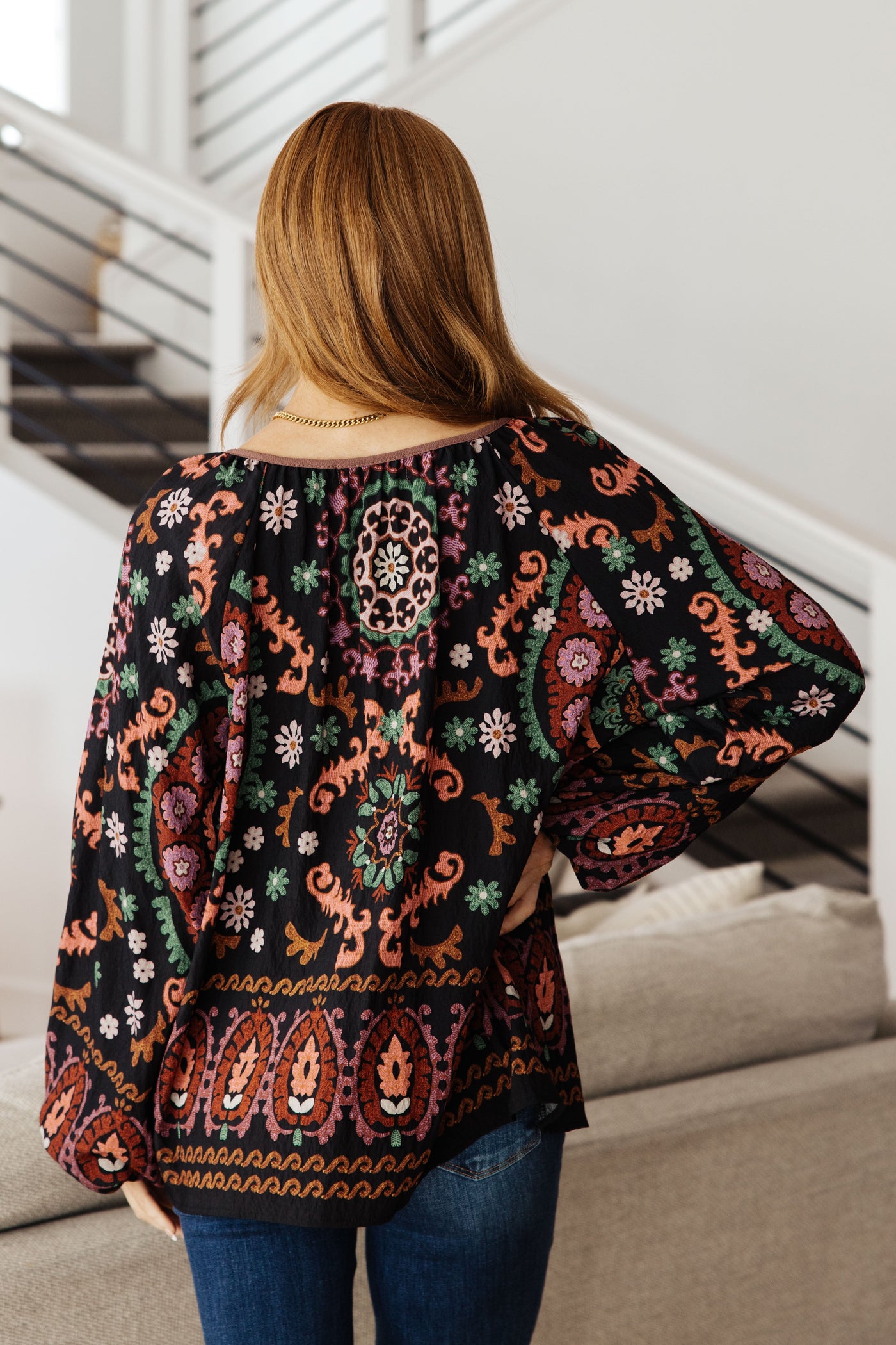 Be daring and vibrant with this I Feel That Peasant Blouse. This gorgeous blouse is beautifully textured with a woven fabric, features a tie-neck keyhole, and is accented with a vibrant boho border print in rich colors