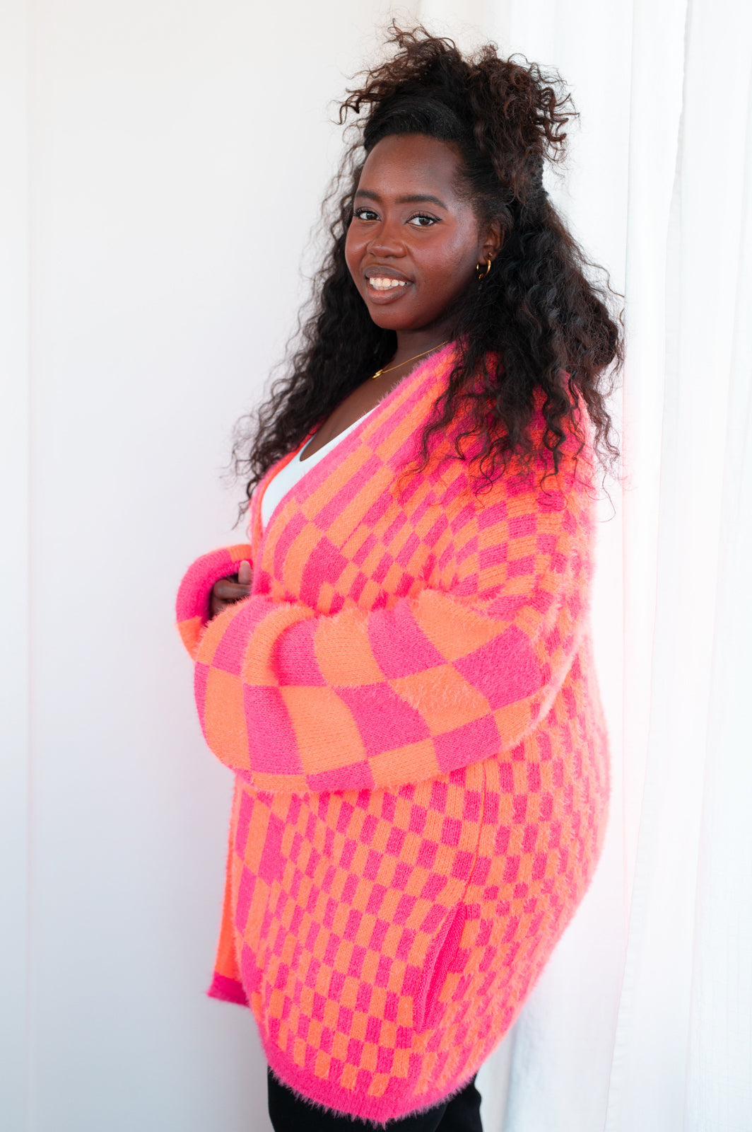 Stay warm and stylish in the Noticed in Neon Checkered Cardigan in Pink and Orange! This loud yet cozy cardigan features a sweater knit, and an open front design for a classic-yet-chic look