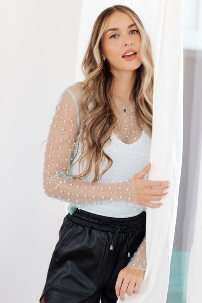 Make waves in the Pearl Diver Layering Top! This mesh long sleeve top is embellished with faux pearls and rhinestones, creating a unique and eye-catching look