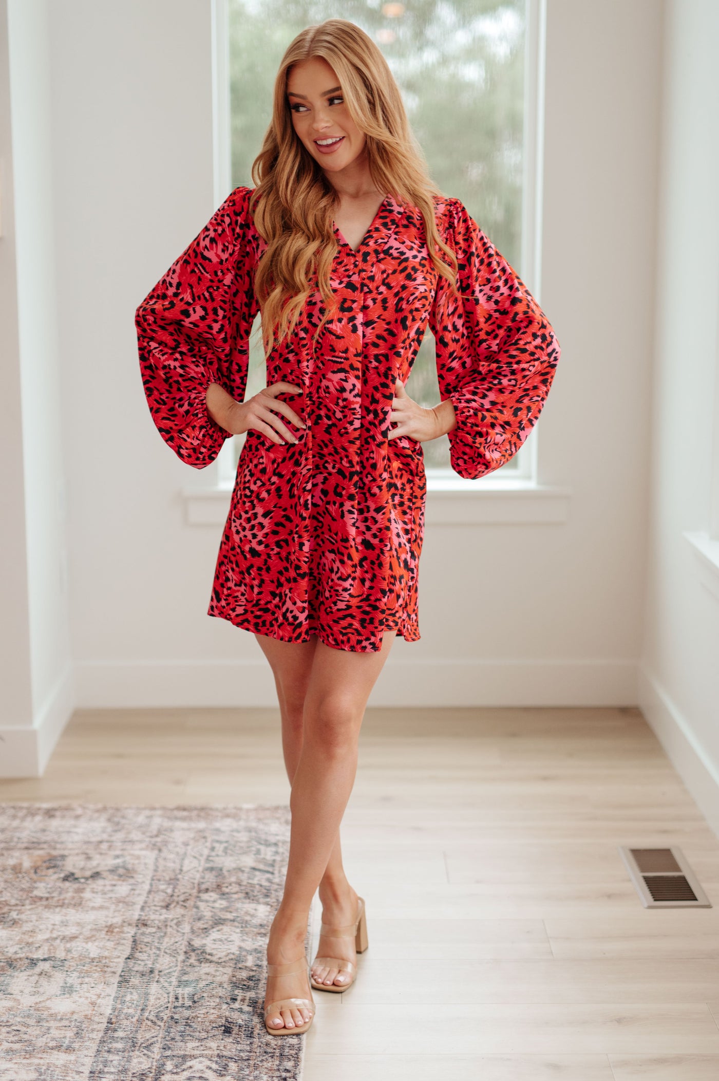 Featuring a vibrant color, all-over animal print, v-neckline, and voluminous balloon sleeves, this dress is sure to help you stand out. Live life on the wild side!