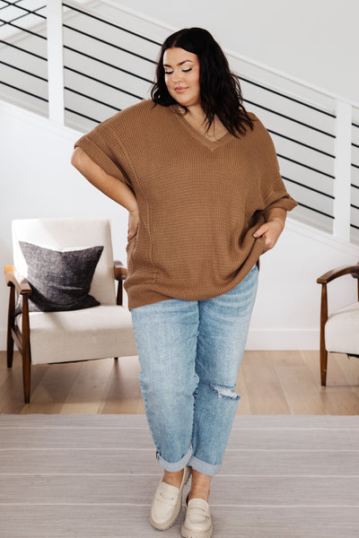 Its lightweight knit fabric, v-neckline, and cuffed short sleeves make it perfect for chillier days. Look great while feeling cozy any time of the year.