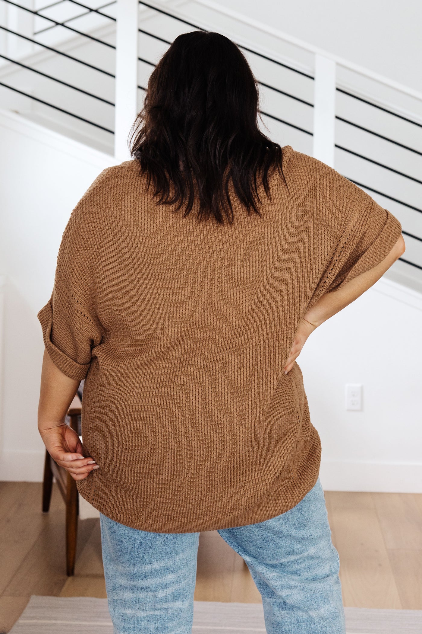 Its lightweight knit fabric, v-neckline, and cuffed short sleeves make it perfect for chillier days. Look great while feeling cozy any time of the year.